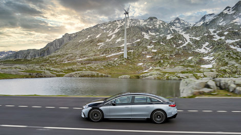 Mercedes car in the mountains with windmill in the background