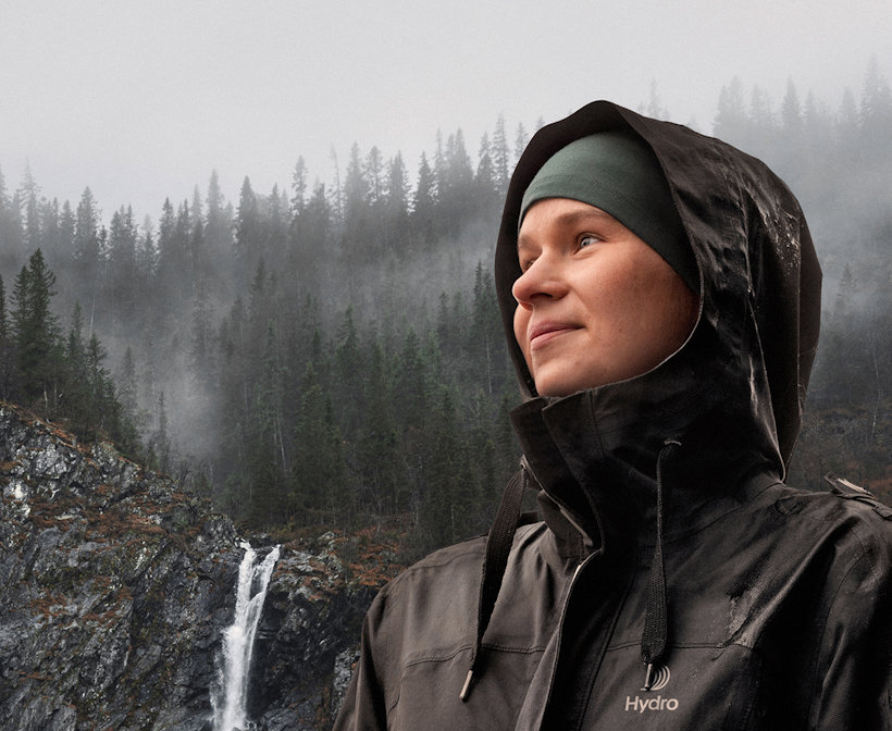 a person wearing a hoodie and standing on a snowy hill a person wearing a hoodie and standing on a snowy hill